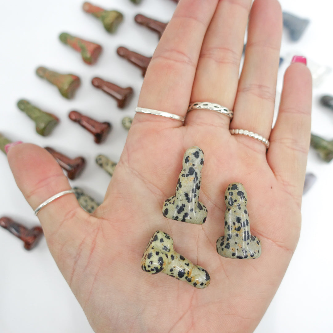 Crystal-shaped phalluses carved from Dalmatian Jasper, Unakite, Clear Quartz, Blue Quartz, Howlite, Moss Agate, and Green Aventurine