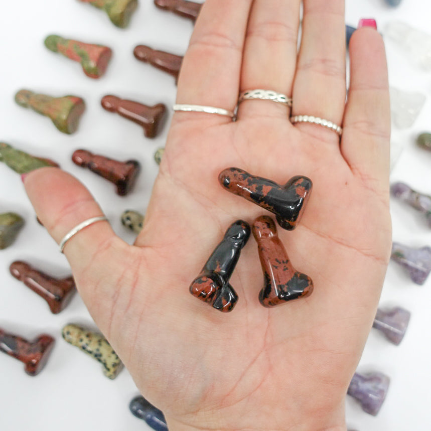 Crystal-shaped phalluses carved from Dalmatian Jasper, Unakite, Clear Quartz, Blue Quartz, Howlite, Moss Agate, and Green Aventurine