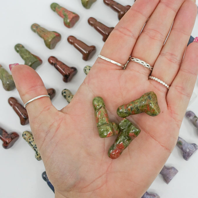 Crystal-shaped phalluses carved from Dalmatian Jasper, Unakite, Clear Quartz, Blue Quartz, Howlite, Moss Agate, and Green Aventurine