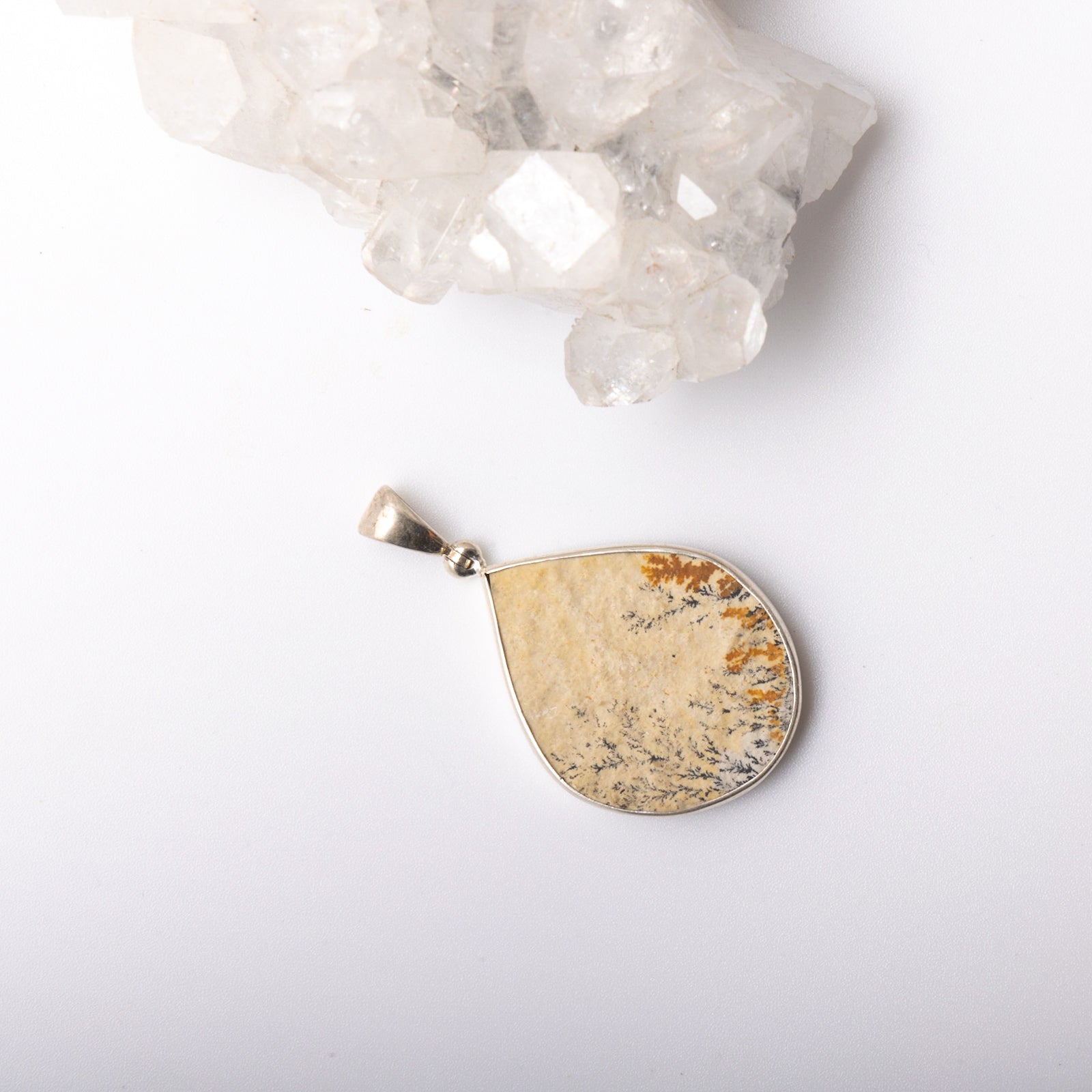 Dendrite Pendant - Connect with the Earth's energy and find stability with our Dendrite pendant. Stone roughly measures 75" +. Each pendant is uniquely chosen for you.