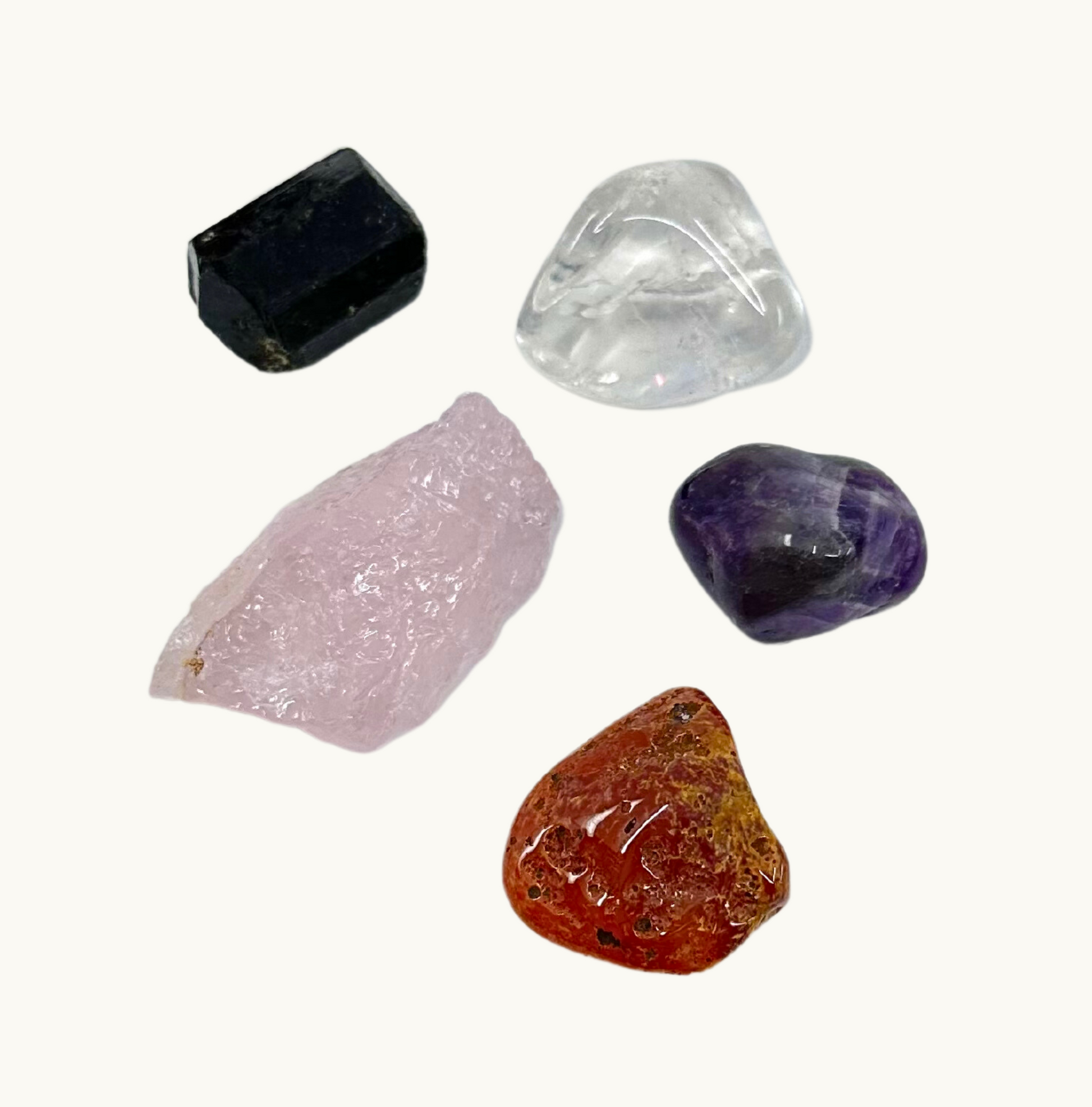 Magical Crystal Kit for Kids: Includes Amethyst, Rose Quartz, Clear Quartz, Black Tourmaline, and Carnelian - A colorful assortment of crystals arranged on a vibrant background, inviting young explorers to embark on a journey of discovery and wonder. Perfect for children, parents, educators, and crystal enthusiasts.