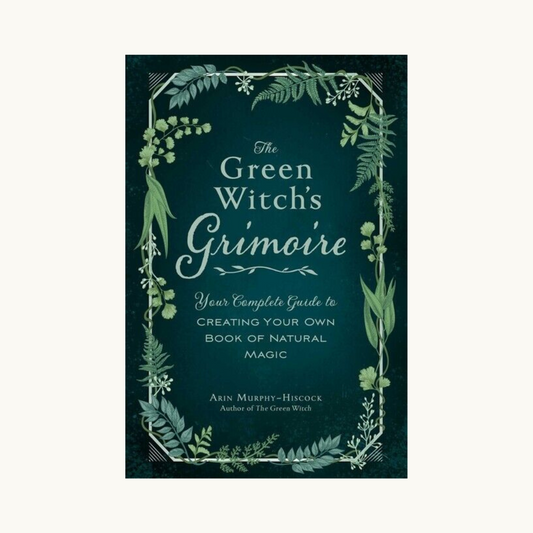 Cover of the Green Witches Grimoire book featuring a lush green forest scene with a rustic, hand-lettered title in cursive font.