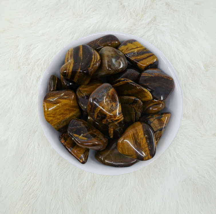 "Tumbled Tiger's Eye Crystals: Stone of balance, vitality, and practicality. Enhances mental clarity and strength to overcome fatigue, fear, and discouragement. Pairs well with Malachite. Chakras: Root, Sacral, Solar Plexus. Physical benefits: Blood fortifier."