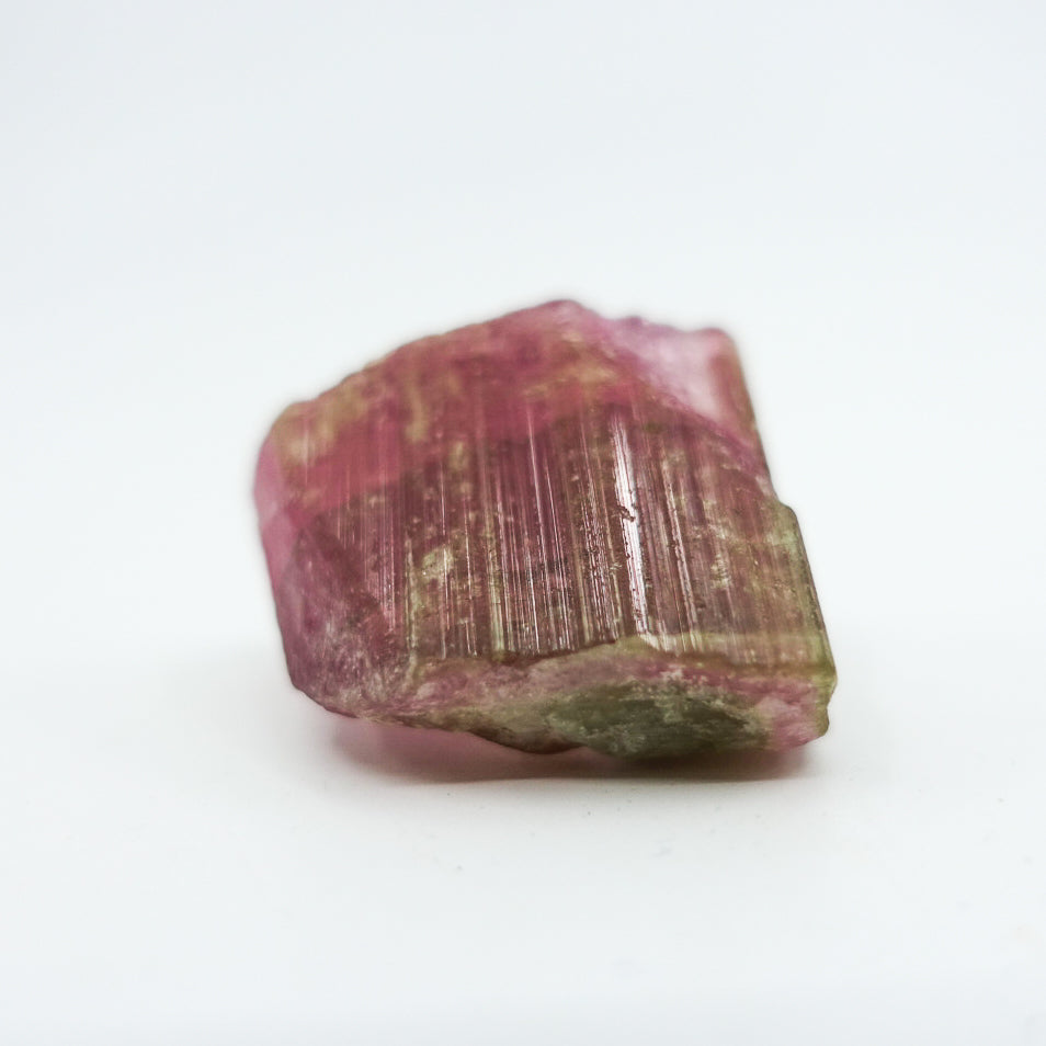 Watermelon tourmaline crystal, approximately measuring 1.5" x 1". Ideal for heart chakra activation, calming energy, and healing. Shapes and sizes may vary.