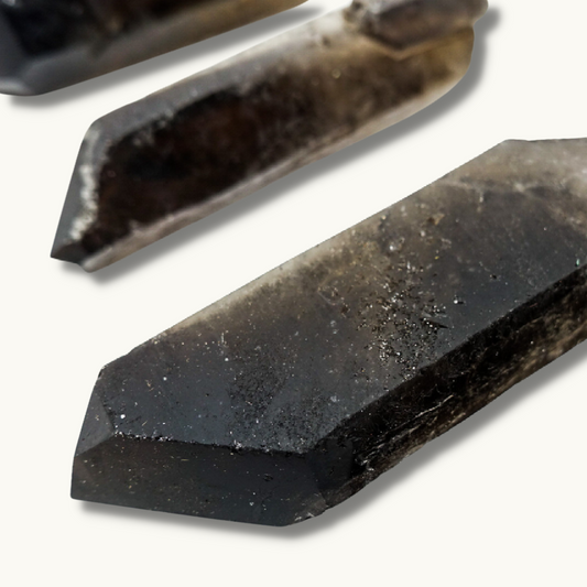 Smoky Quartz points, approximately 2.5"-4.5" in size, known for their grounding and aura purification properties.
