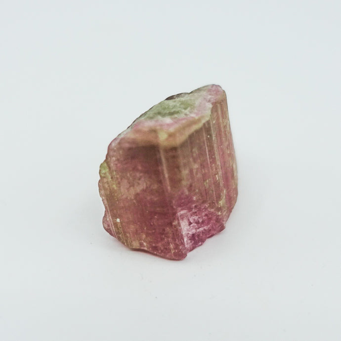 Watermelon tourmaline crystal, approximately measuring 1.5" x 1". Ideal for heart chakra activation, calming energy, and healing. Shapes and sizes may vary.