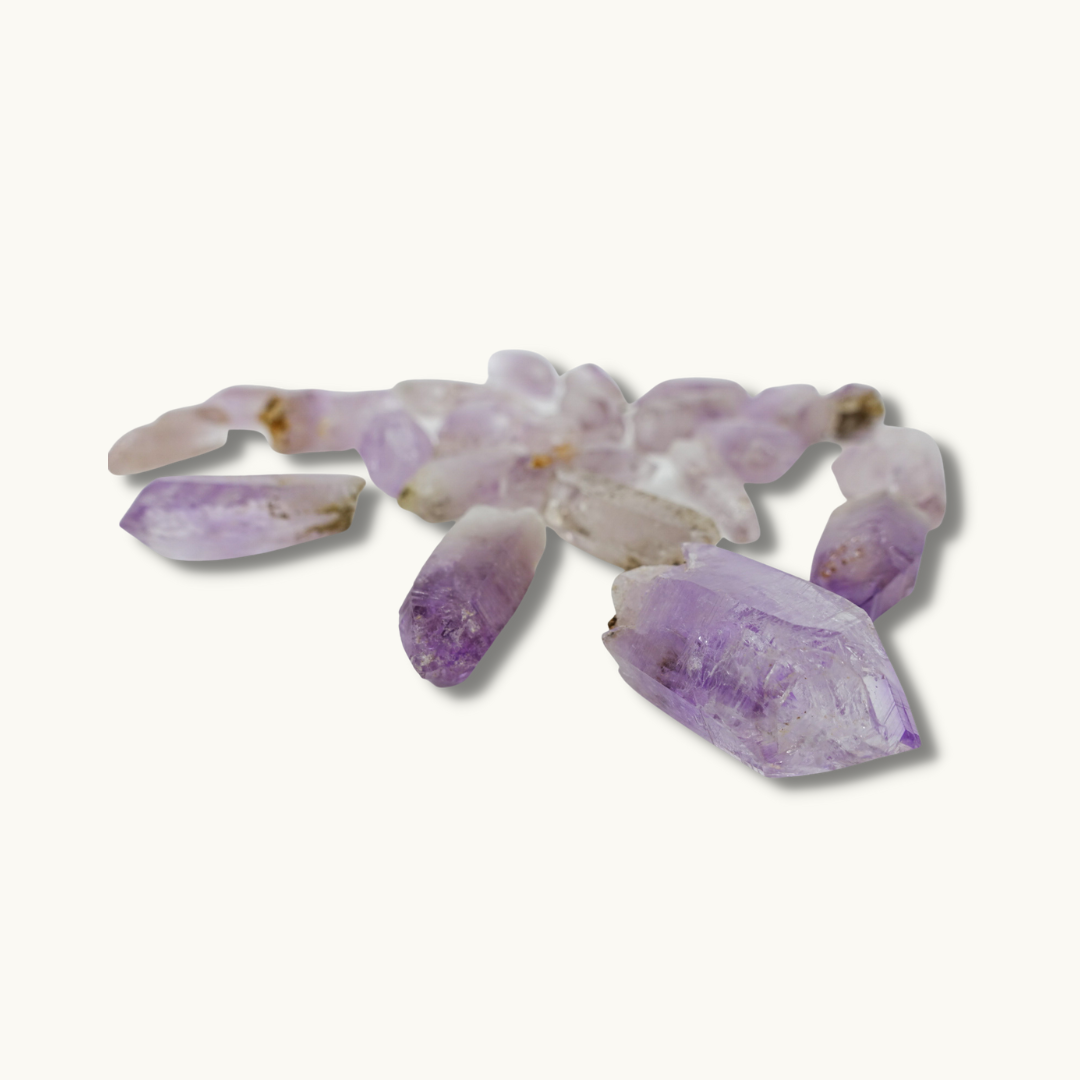 Vera Cruz amethyst crystal, available in small (1.5" x .25"), medium (1.5" + x .50" +), and large enhydro (1.5" x .50" + with trapped water) sizes. Ideal for higher chakra connection, intuition enhancement, and meditation. Shapes and sizes may vary.