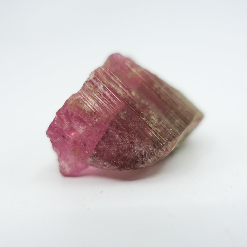 Watermelon tourmaline crystal, approximately measuring 1.5" x 1". Ideal for heart chakra activation, calming energy, and healing. Shapes and sizes may vary.