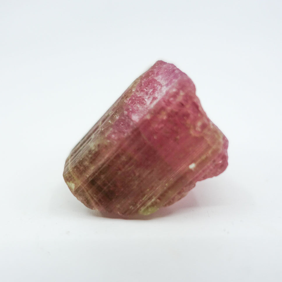 Watermelon tourmaline crystal, approximately measuring 1.5" x 1". Ideal for heart chakra activation, calming energy, and healing. Shapes and sizes may vary.