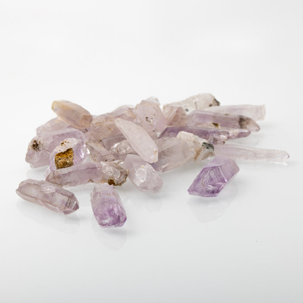 Vera Cruz amethyst crystal, available in small (1.5" x .25"), medium (1.5" + x .50" +), and large enhydro (1.5" x .50" + with trapped water) sizes. Ideal for higher chakra connection, intuition enhancement, and meditation. Shapes and sizes may vary.